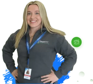 commercial cleaning services company Cleantec employee wearing a branded uniform and ID badge, standing confidently against a clean white background.